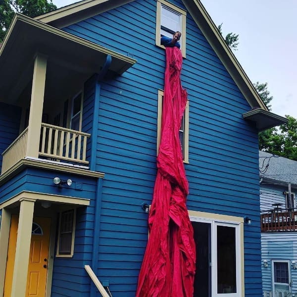 Jimmy Kuehnle lowers fabric for Wiggle, Giggle, Jiggle from his second-storey studio in Cleveland, Ohio. Photo: courtesy of the artist.