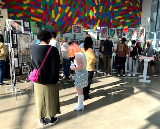Families view student art in the Museum lobby.