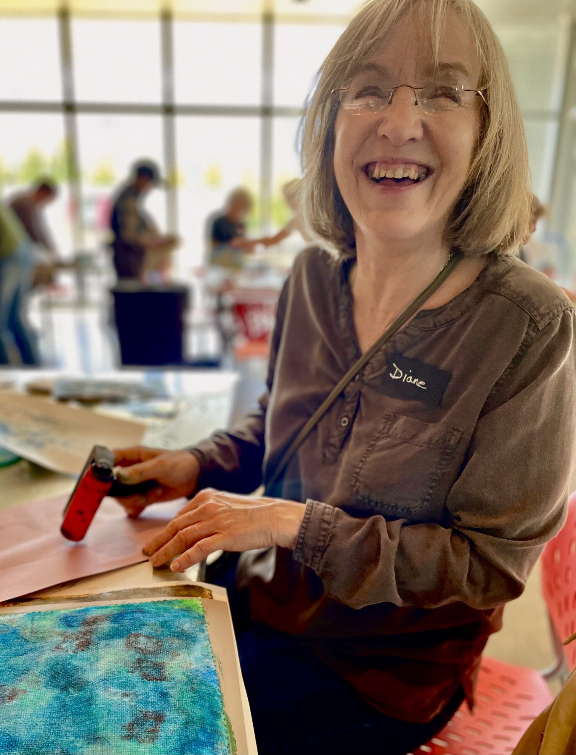 Smiling senior woman making art