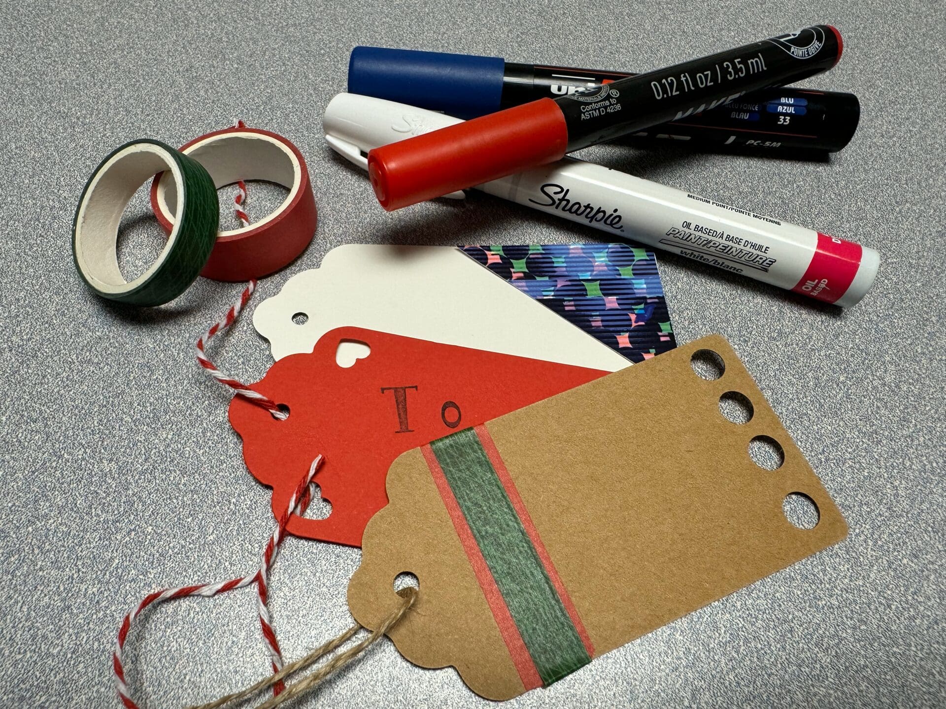 Tags for holiday gifts and pens.