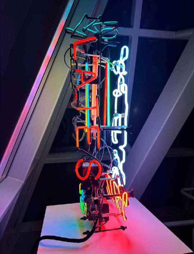 Jeffry Chiplis. Tower of Babel, 2020–21. Fourteen colors of argon and neon, three transformers (two solid-state, one core and coil), steel armature, and cork. Courtesy of the artist.