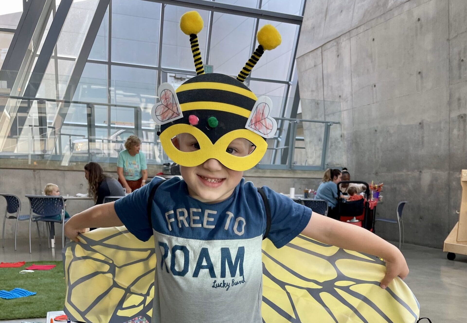 A young child dressed in a bee costume at the Akron Art Museum.
