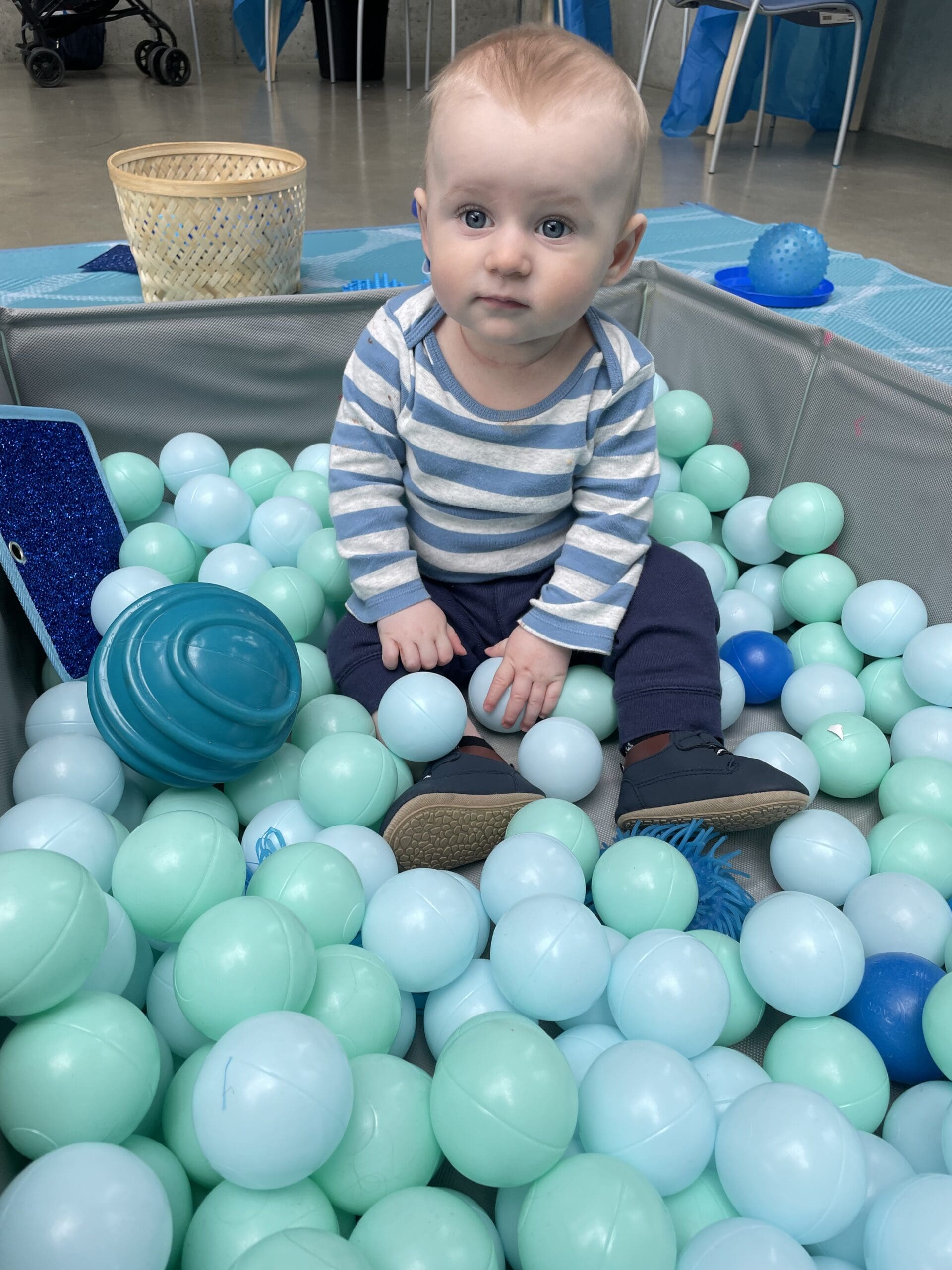 A baby playing during a children's event at the Akron Art Museum.